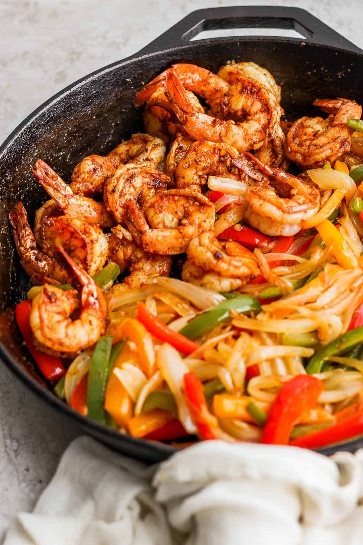 A skillet with shrimp fajitas.