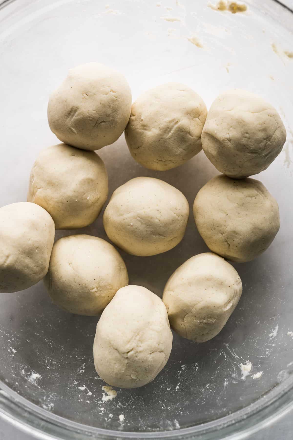 Balls of fresh masa in a bowl ready to be pressed.