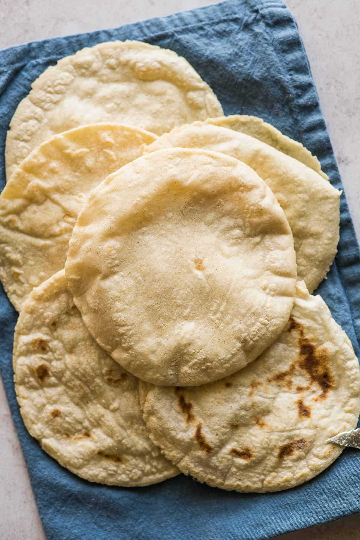 Cooked gorditas on a towel ready to be filled.