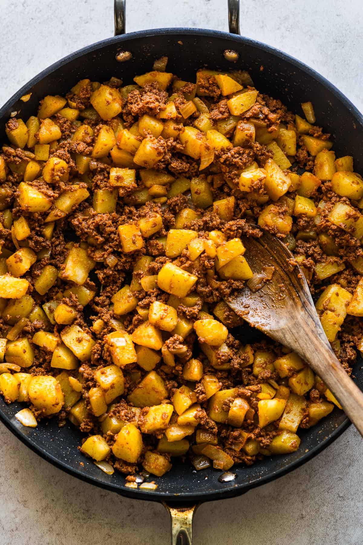 Papas con chorizo filling in a skillet.