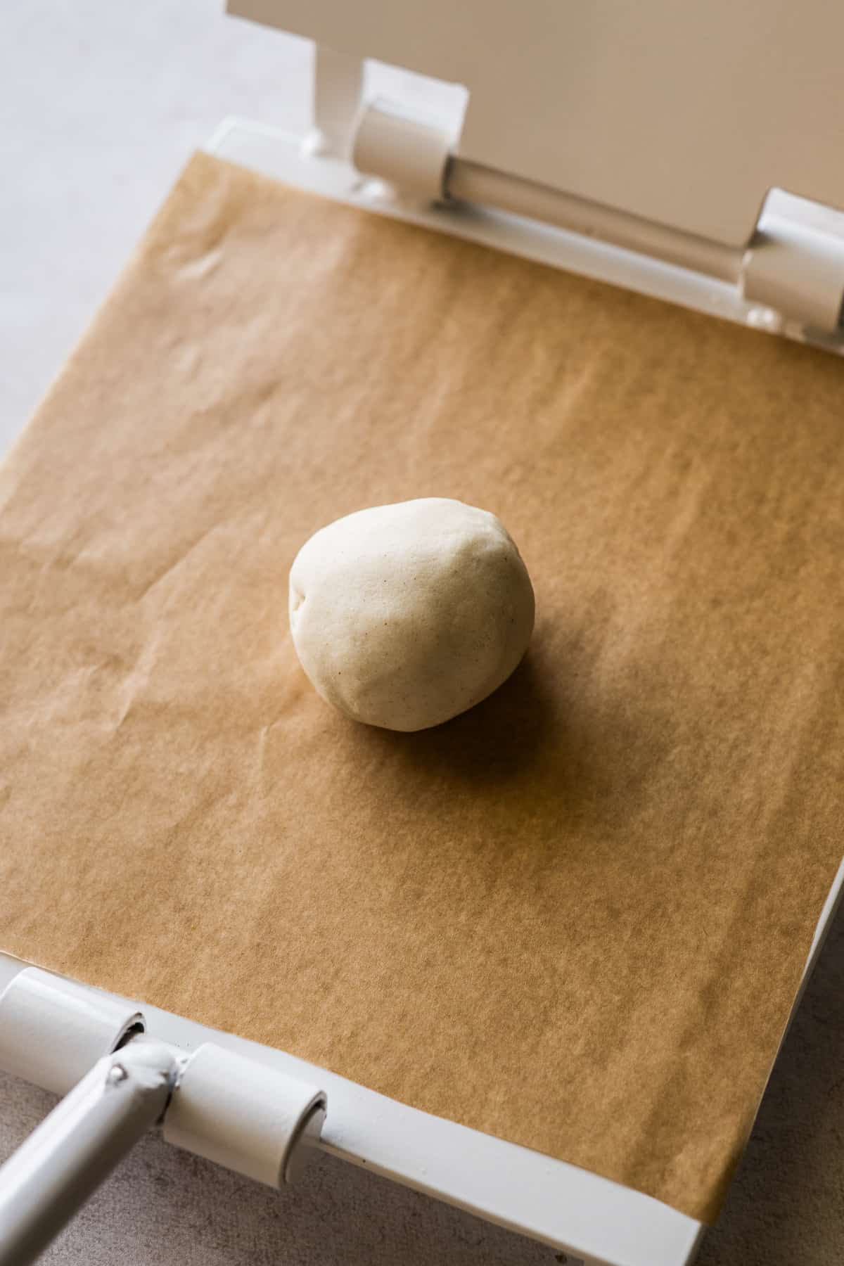 A ball of masa on a tortilla press.