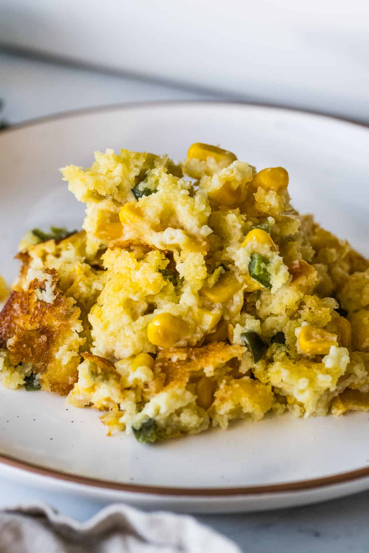 Green chili corn casserole on a plate.