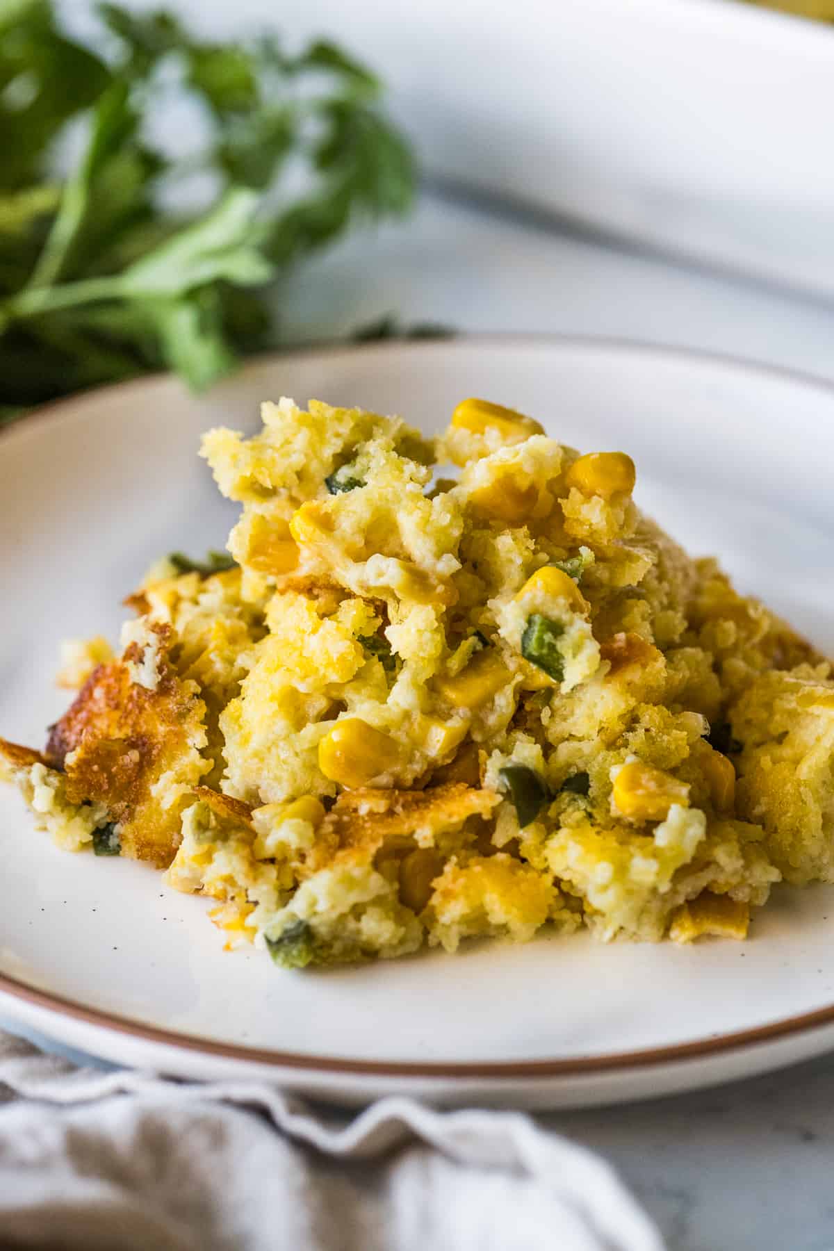 Green Chili Corn Casserole on a plate ready to eat.