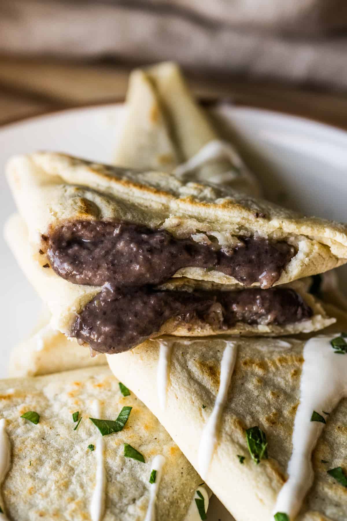 A tetela cut in half to show the black bean and cheese filling.