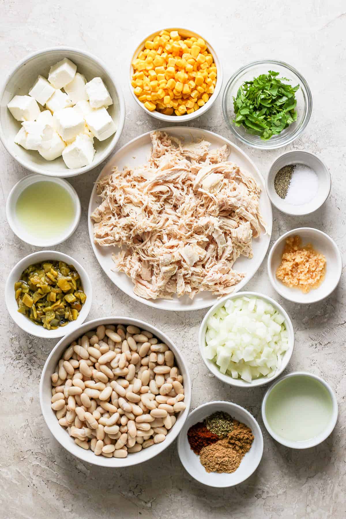 Ingredients in white chicken chili on a table.