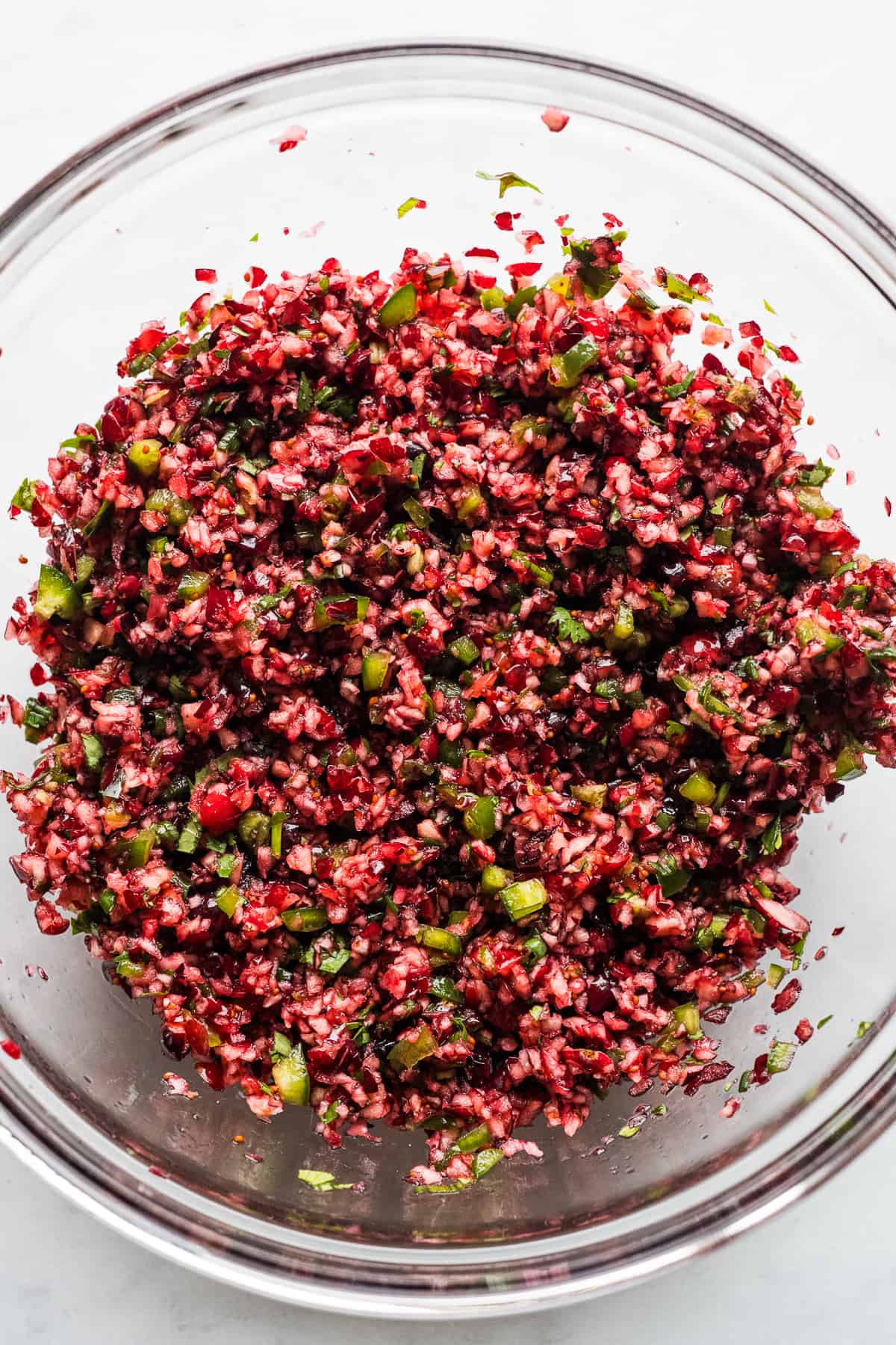 Vibrant cranberry salsa in a large mixing bowl.