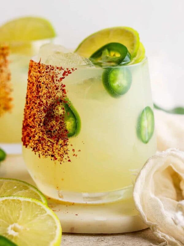 Spicy margarita in a glass rimmed with tajin.