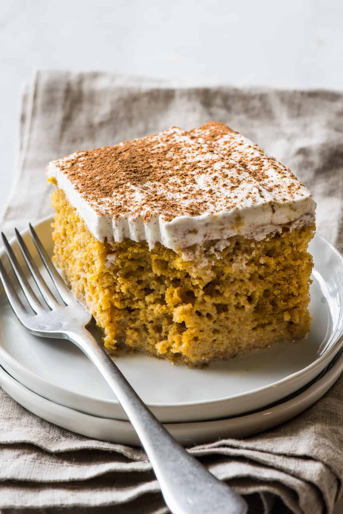 A piece of pumpkin tres leches cake on a plate