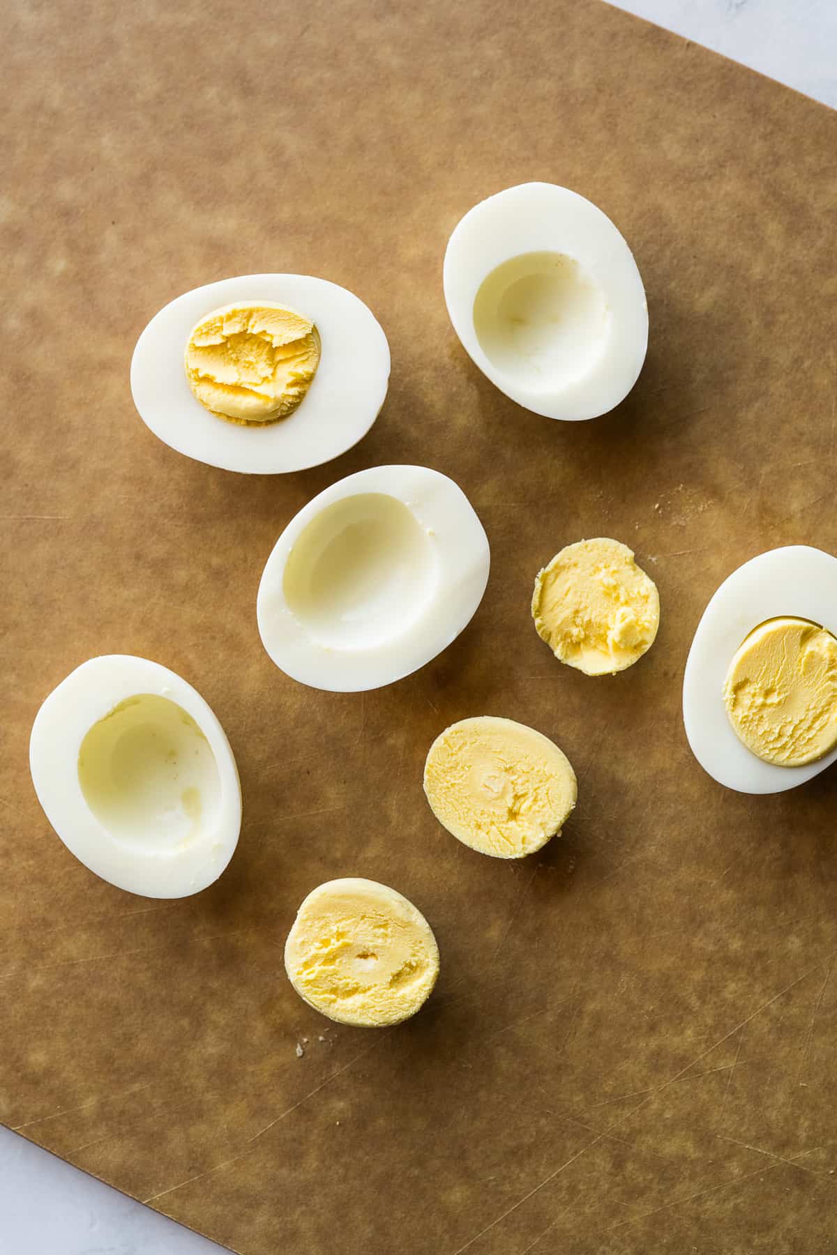 Hard boiled eggs sliced in half and the yolks taken out.