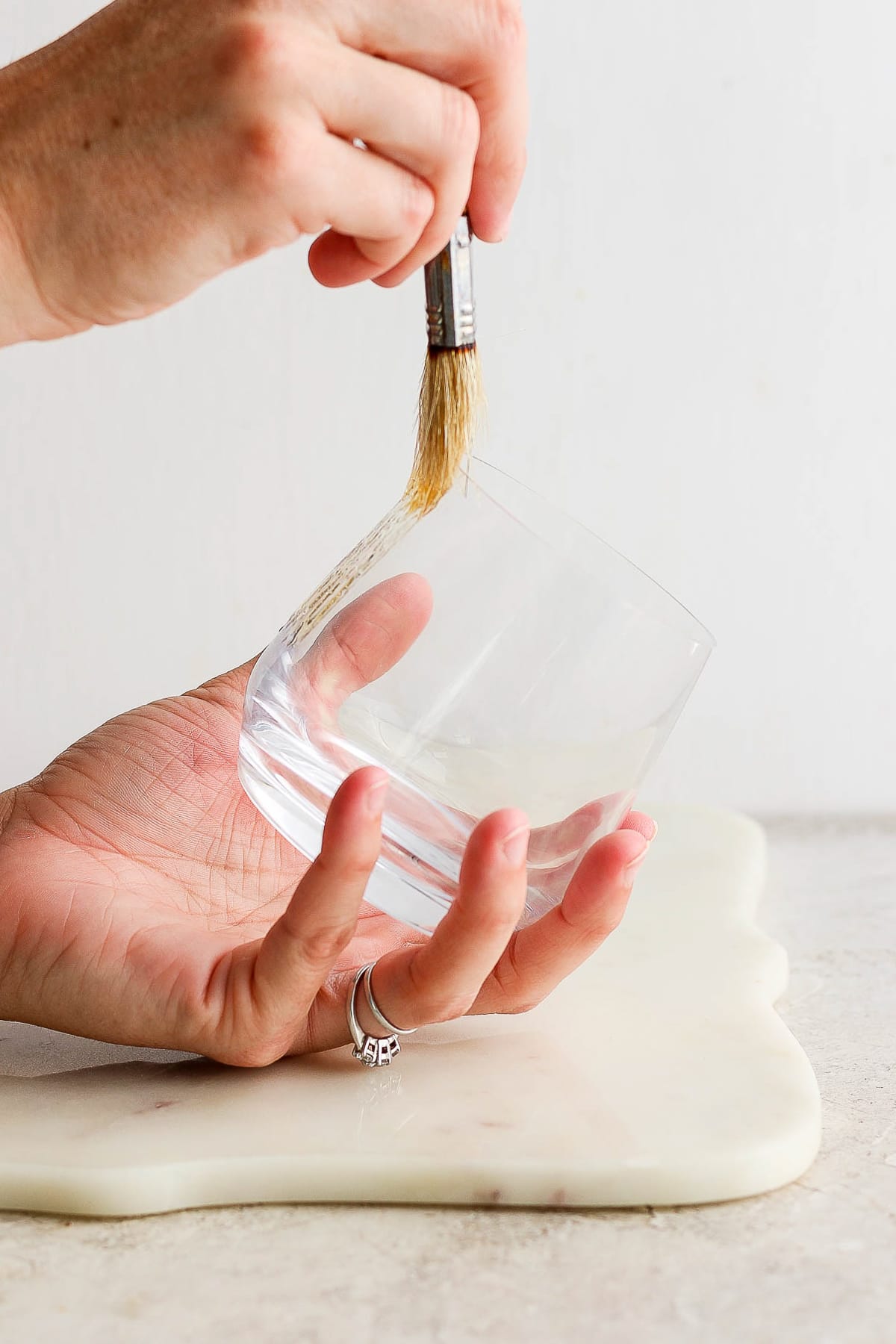 Rimming a margarita glass with tajin