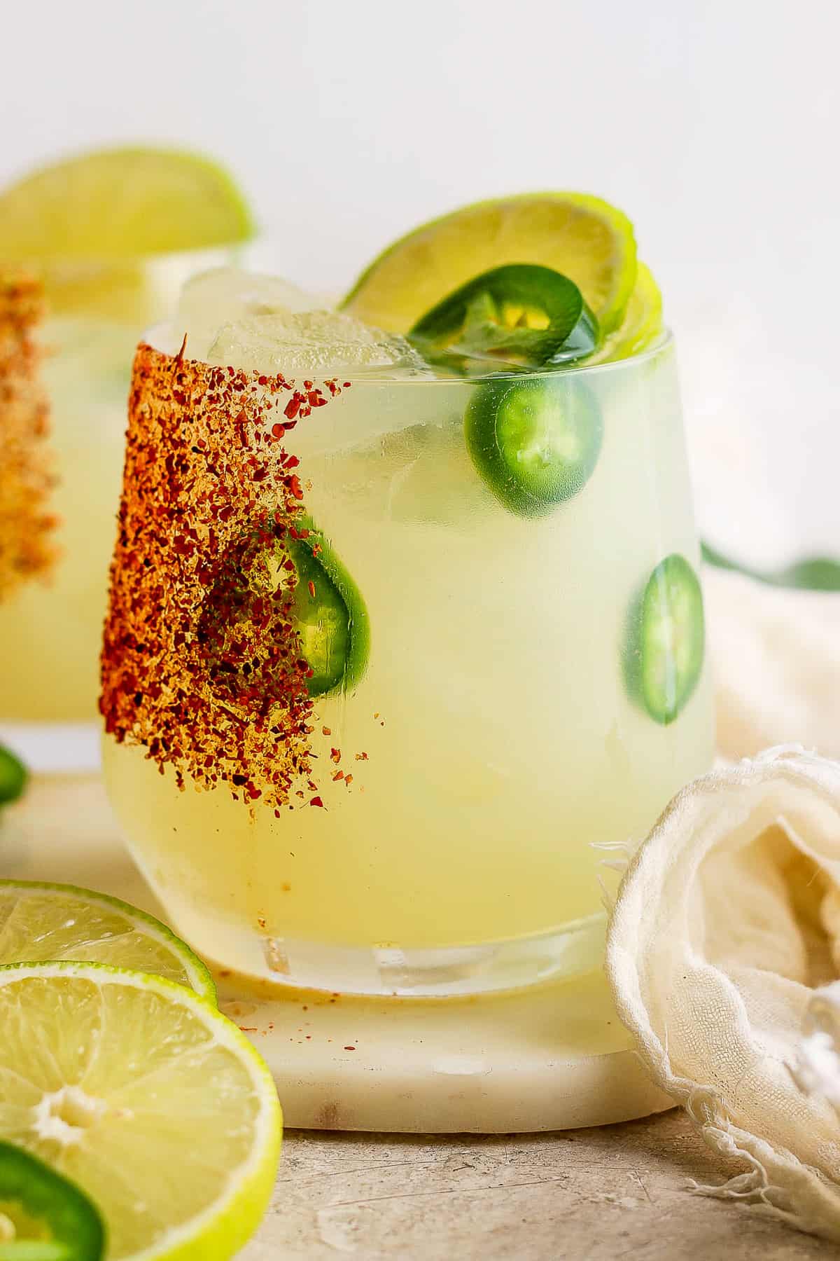 Spicy margarita in a glass rimmed with tajin.