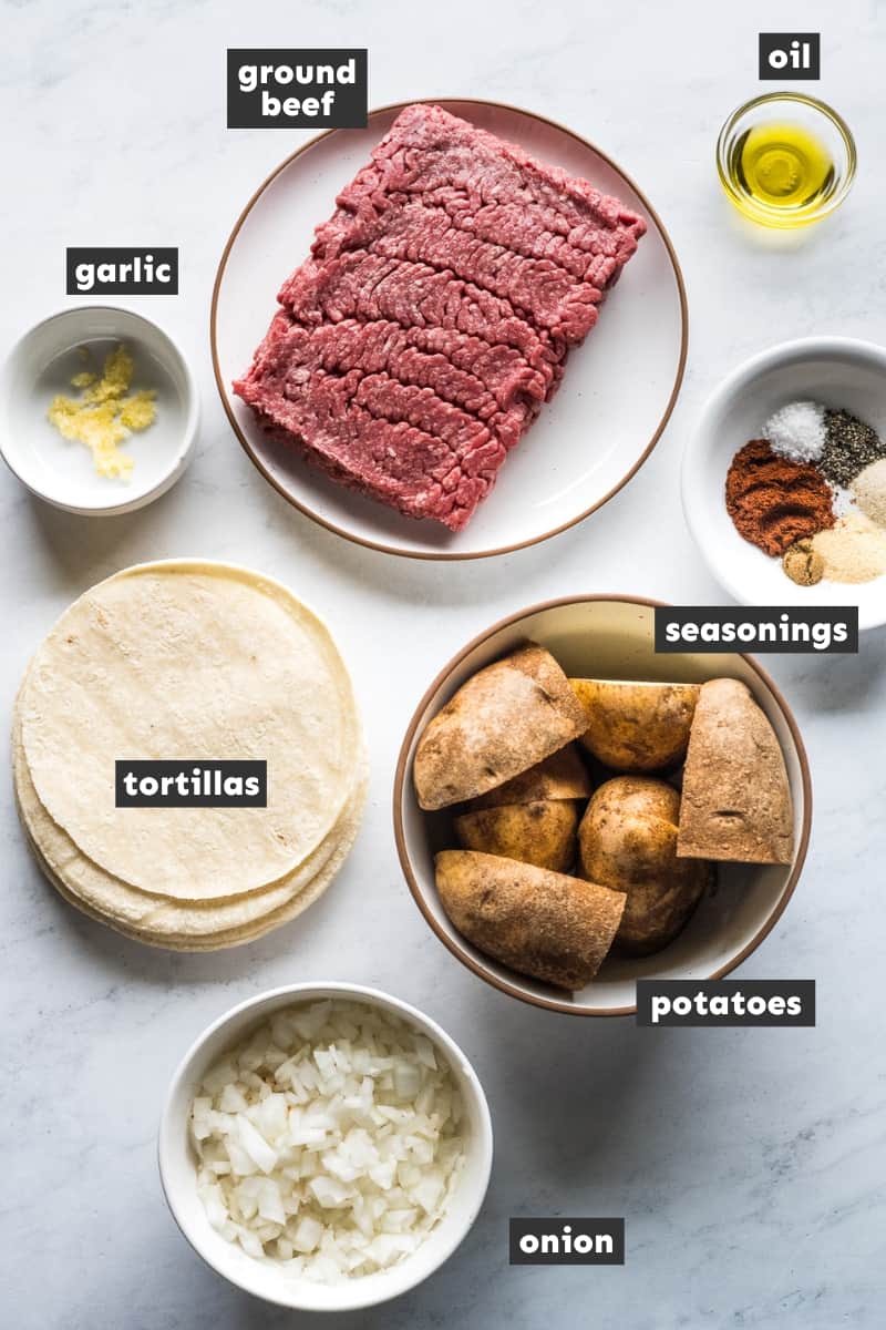 Ingredients in tacos dorados on a table.