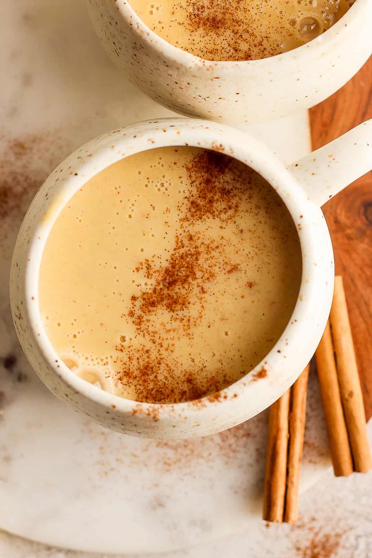Atole de Elote in a mug from the top down with a dusting of ground cinnamon.