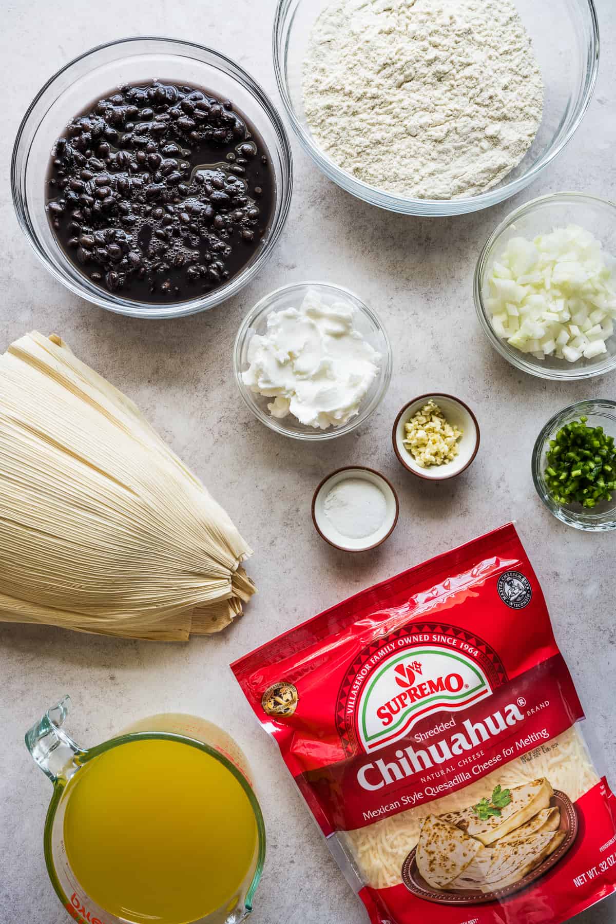 Ingredients in bean and cheese tamales on a table.