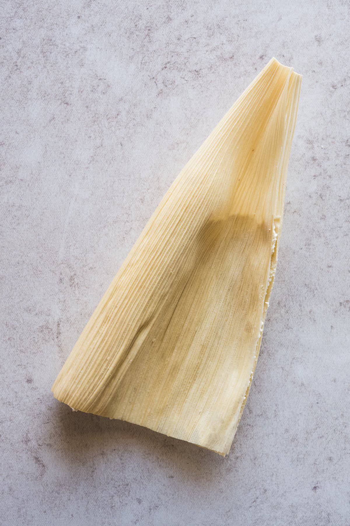 A tamal closed in half.