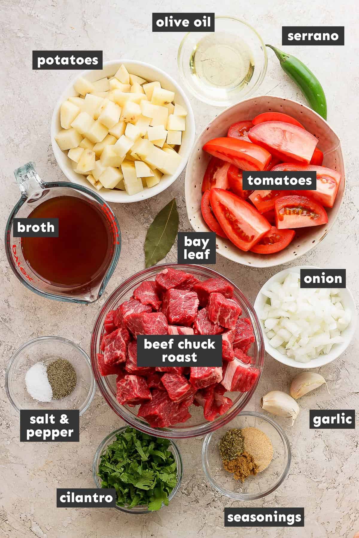 Ingredients in carne con papas on a table.