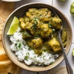 Chile verde in a bowl garnished with cilantro served on top of cilantro lime rice.