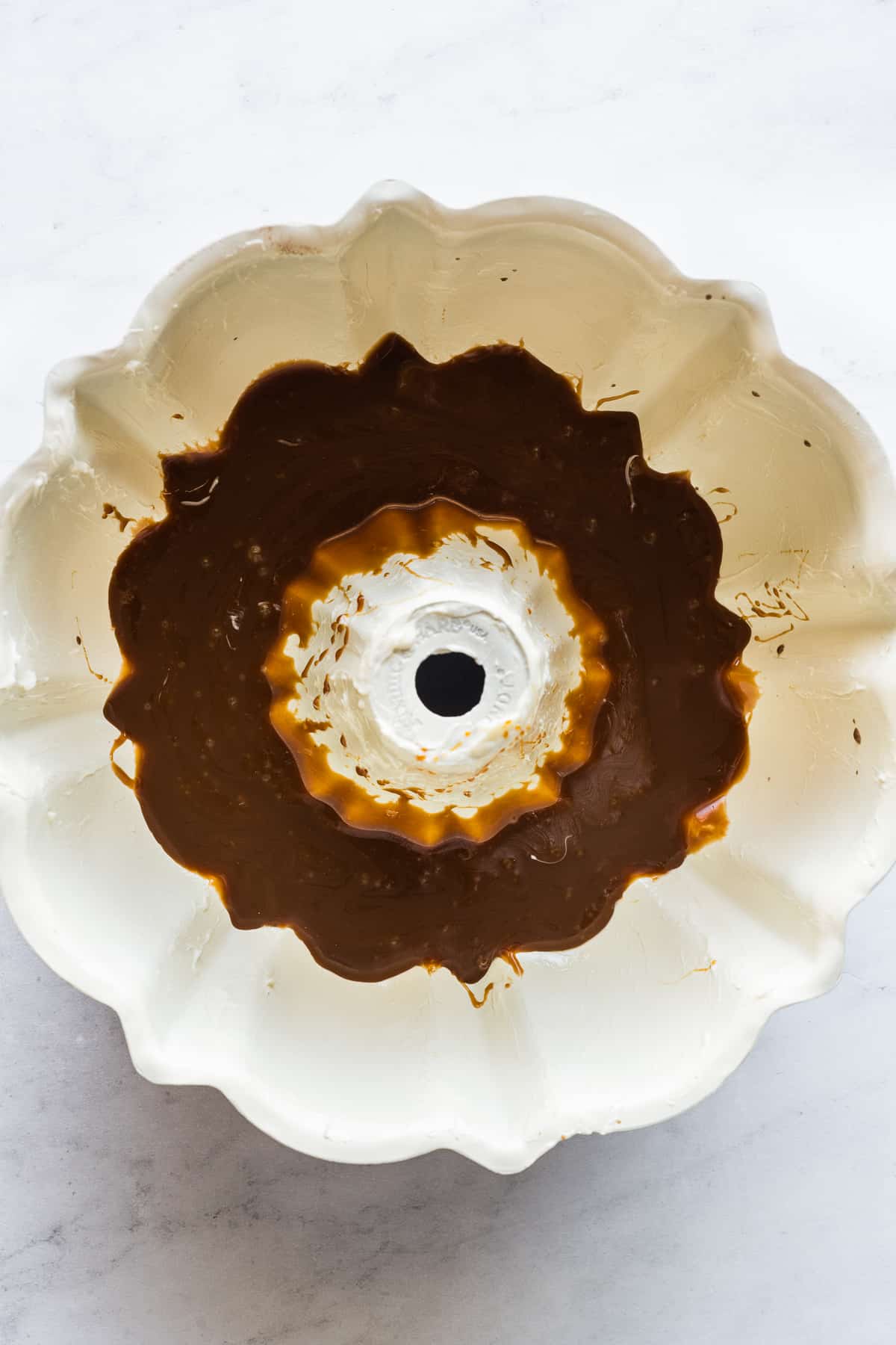 A bundt pan greased with butter and a layer of cajeta on the bottom.
