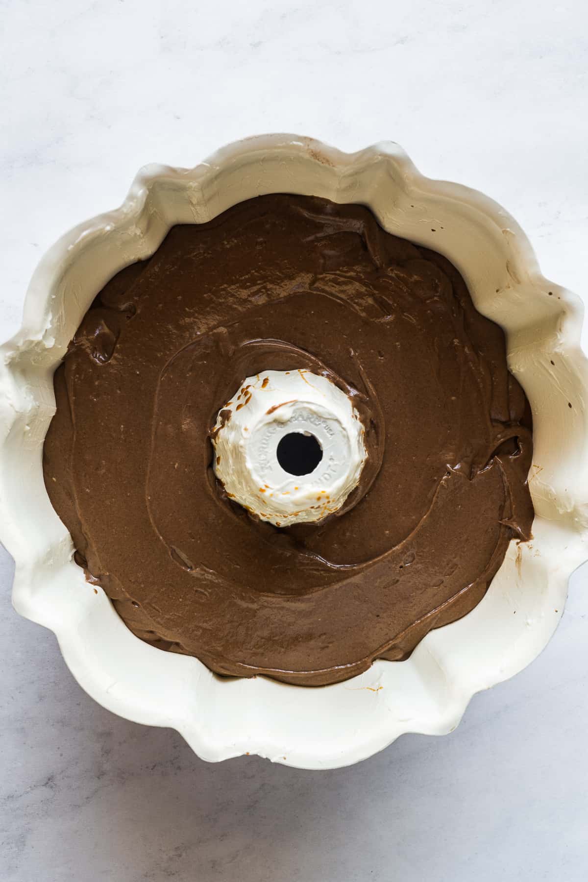 Chocolate cake batter in a bundt pan.