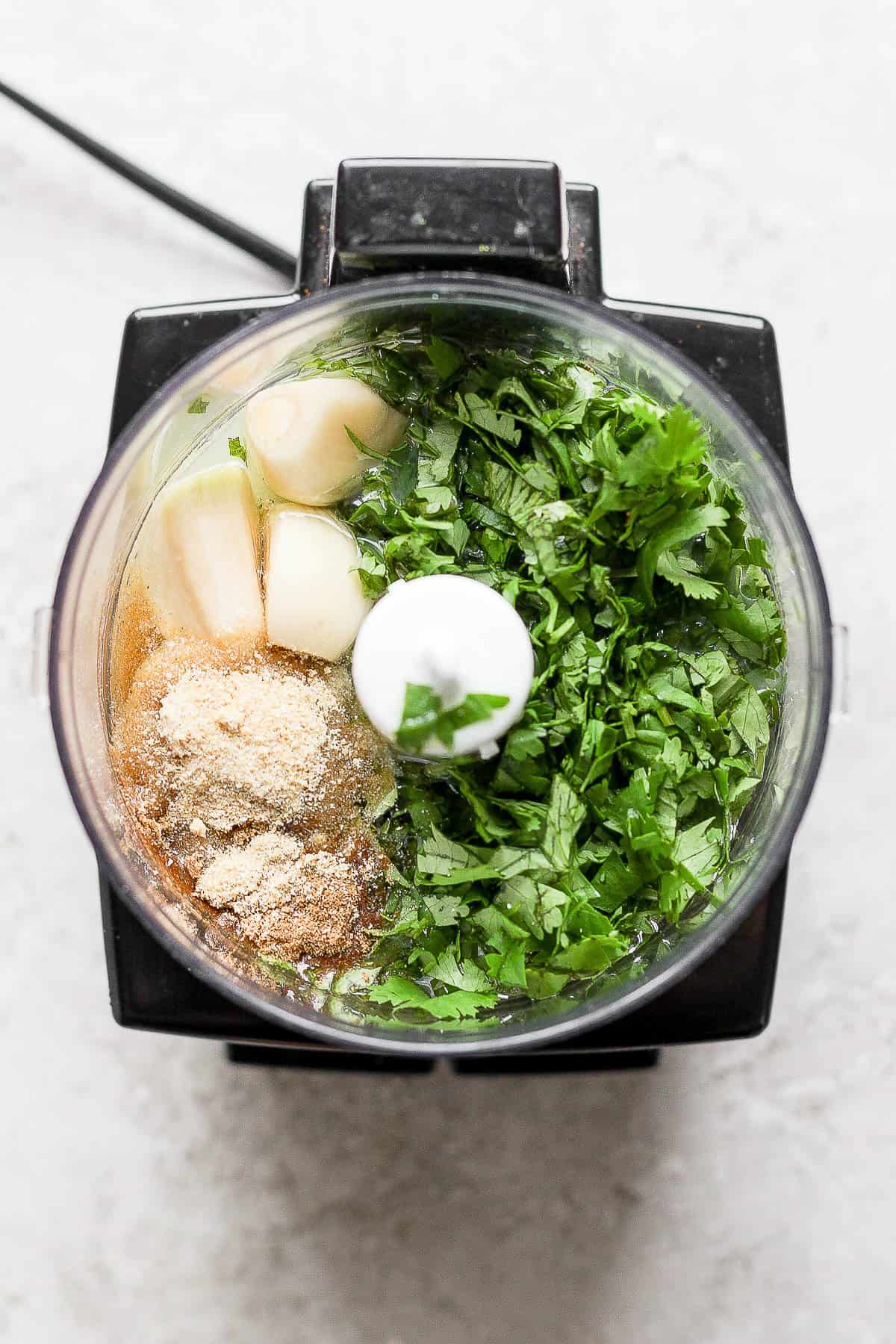 Cilantro, garlic, lime juice, olive oil, and seasonings in a food processor.