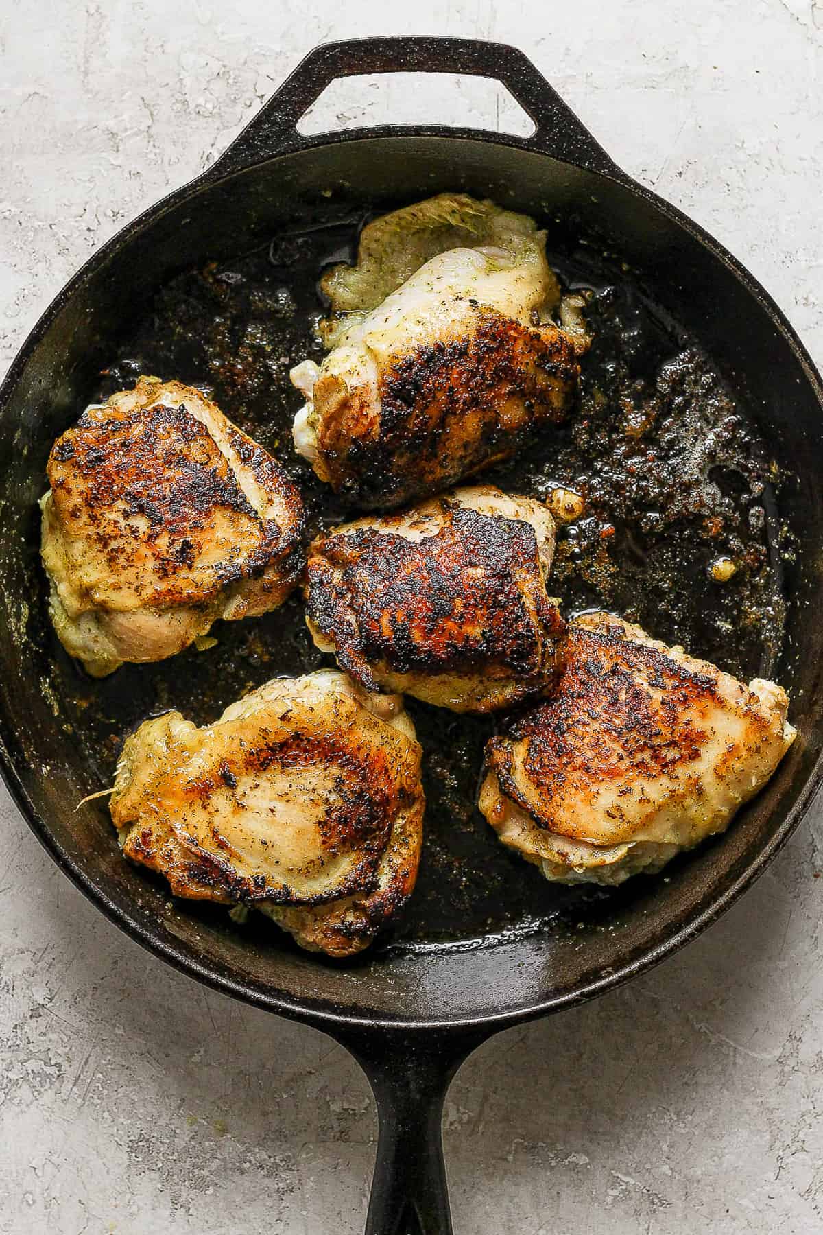Cilantro lime chicken in a skillet with crispy golden-brown skin.