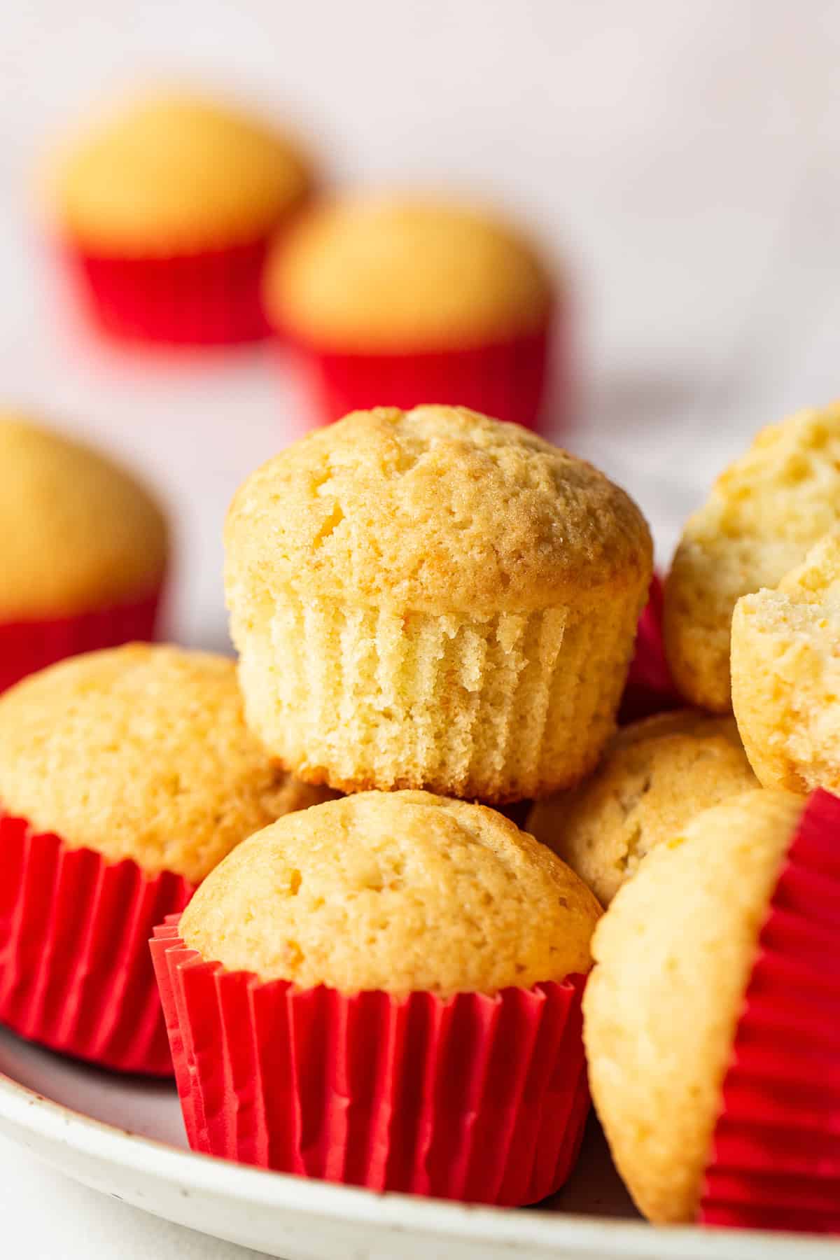 Golden-yellow mantecada muffins baked to perfection with a signature red liner.