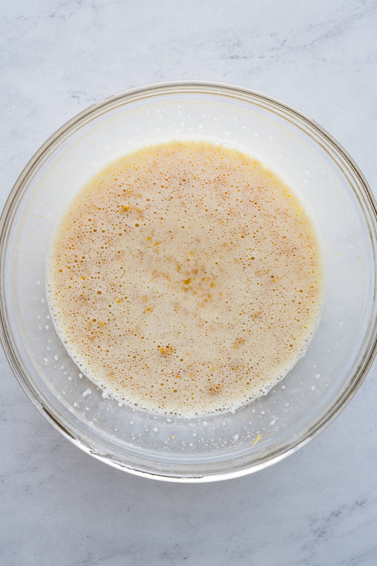 Whisked wet ingredients in a bowl for mantecadas.