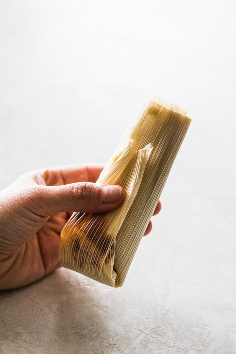 A folded tamal ready to be steamed.