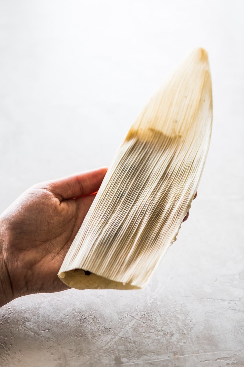 A corn husk folded in half.