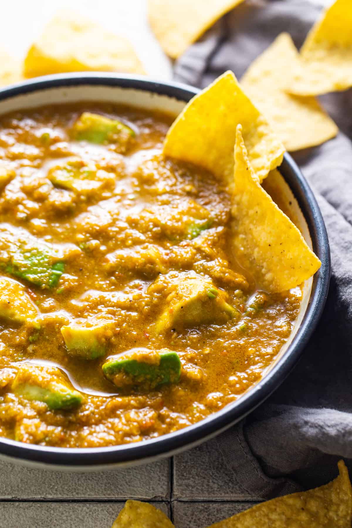 Salsa mexicana in a bowl served with tortilla chips.