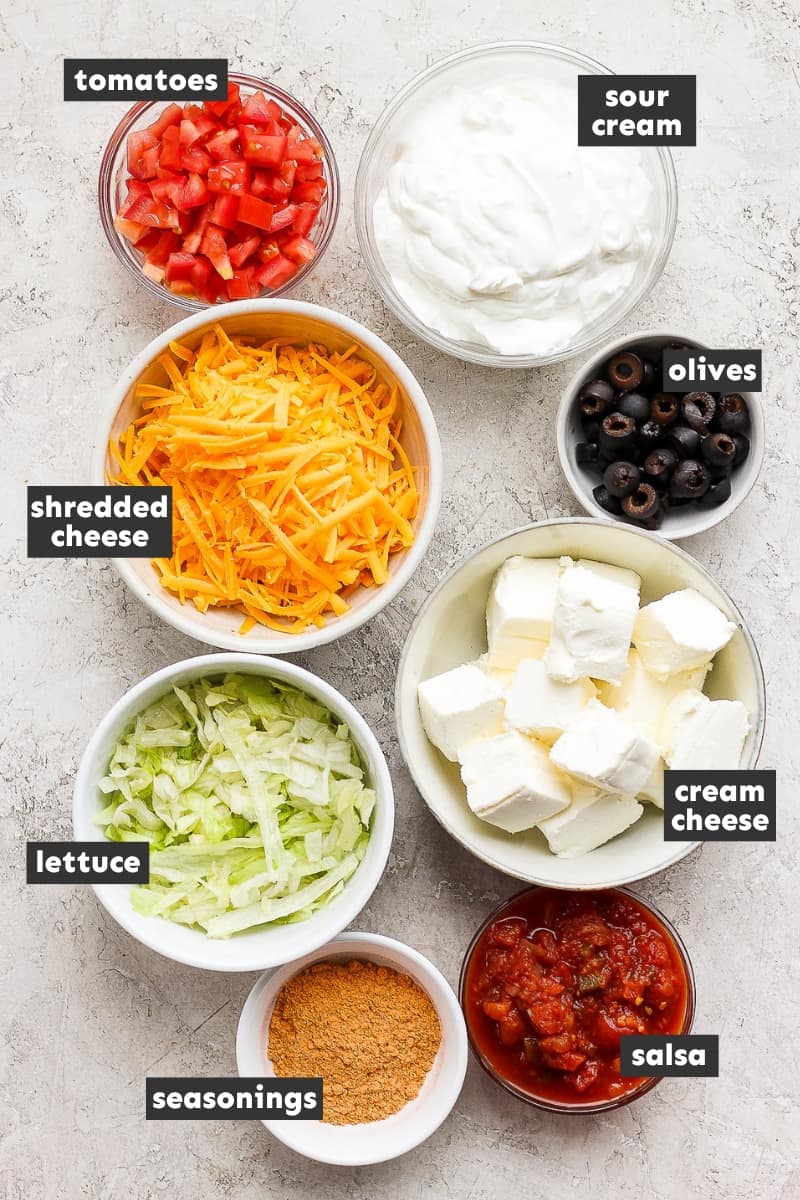 Ingredients in taco dip on a table.
