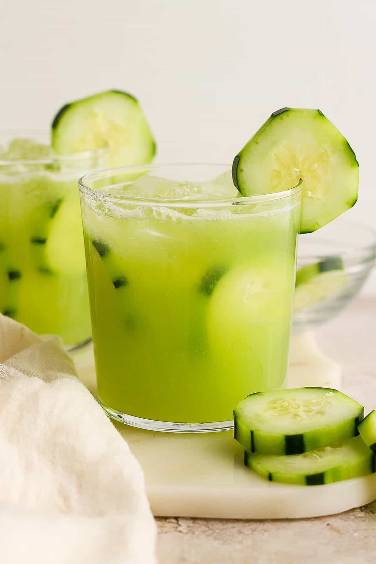 Agua de pepino (Mexican cucumber agua fresca) in glasses garnished with cucumber slices.