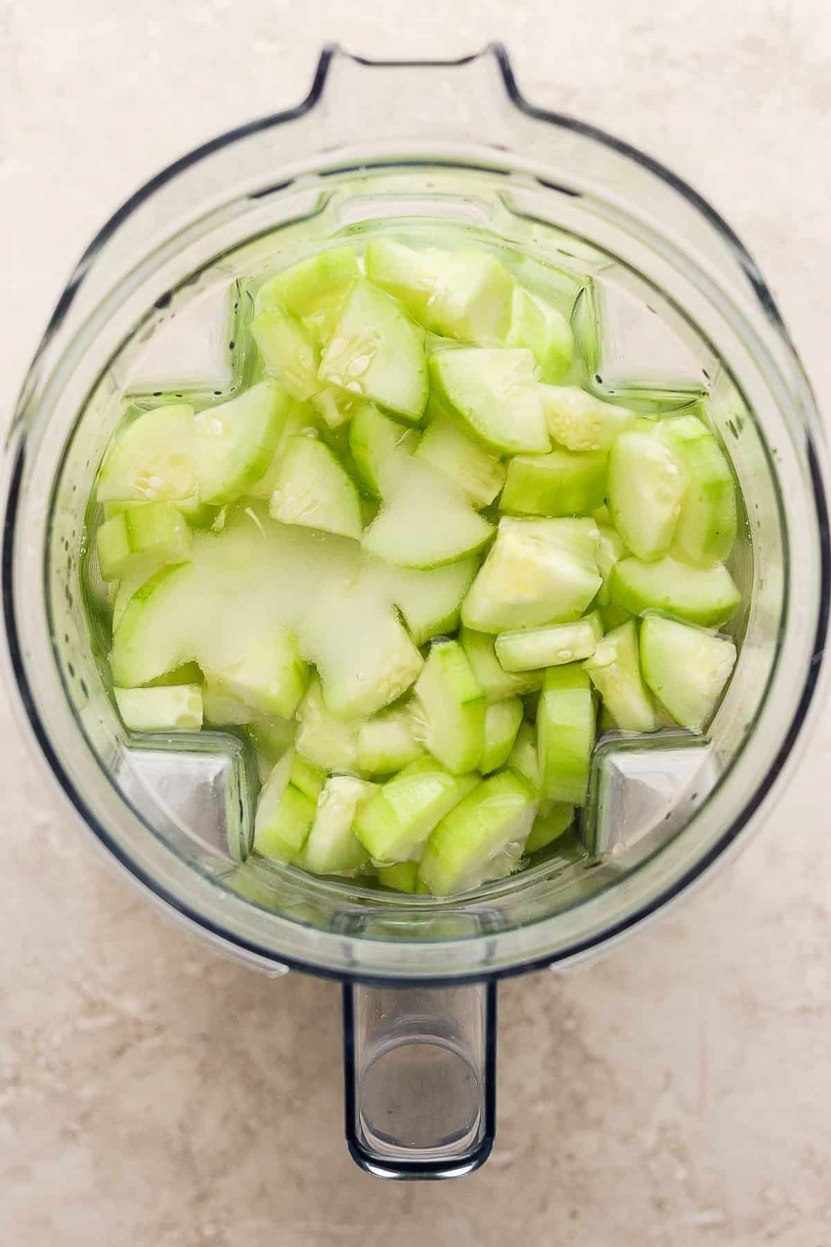 Peeled cucumbers, water, and sugar in a blender.