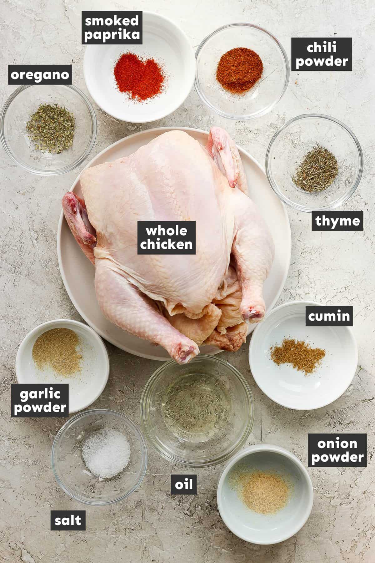 Ingredients in air fryer whole chicken on a table.