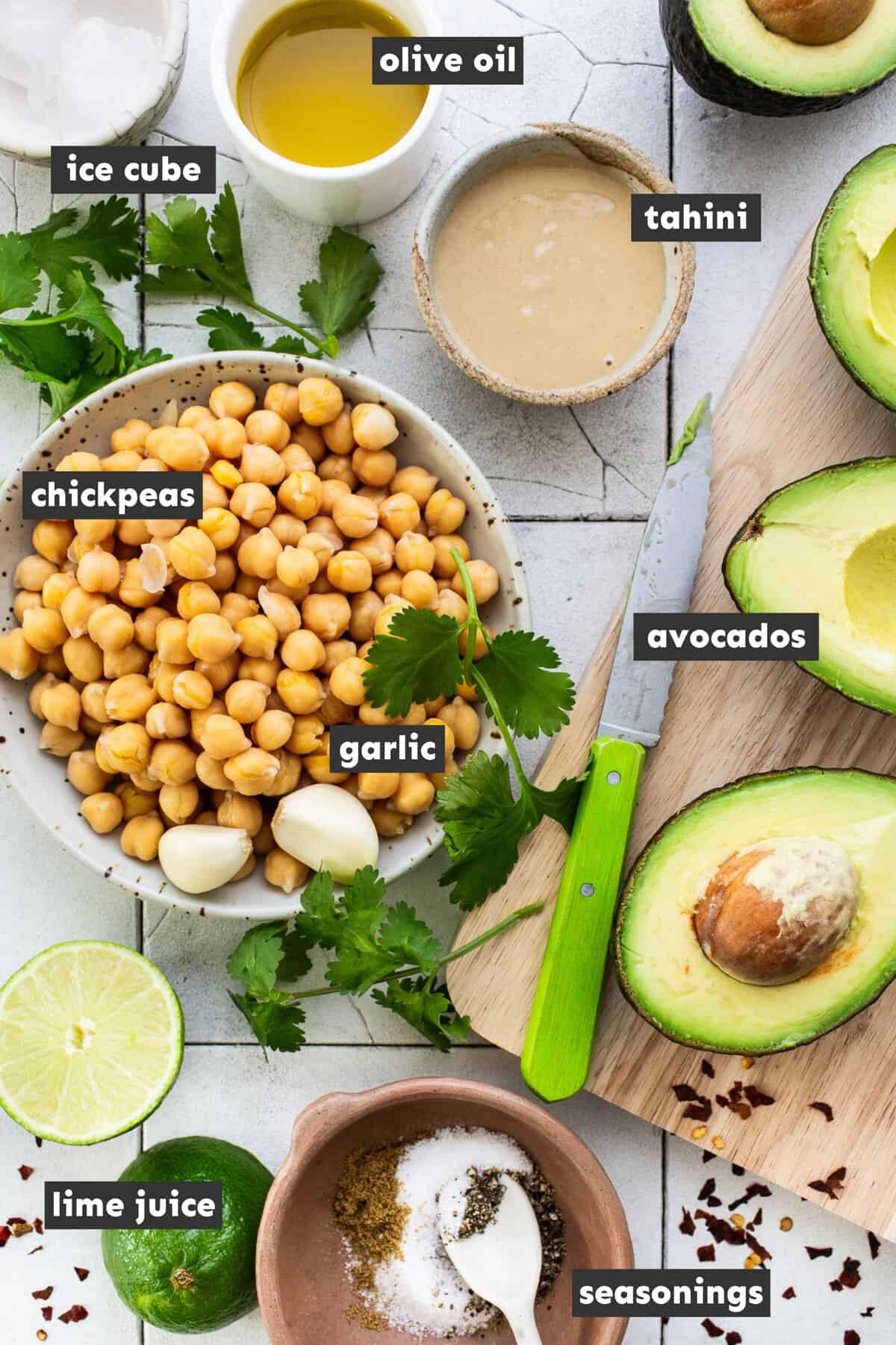 Ingredients for avocado hummus on a table.