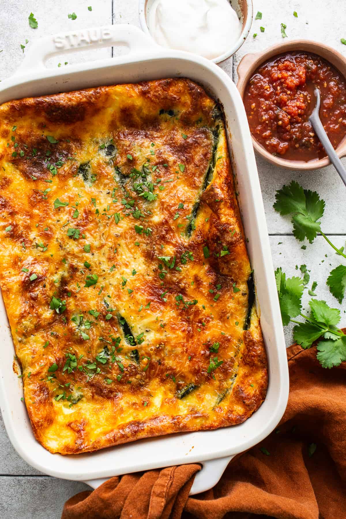 Chile relleno casserole garnished with fresh cilantro.