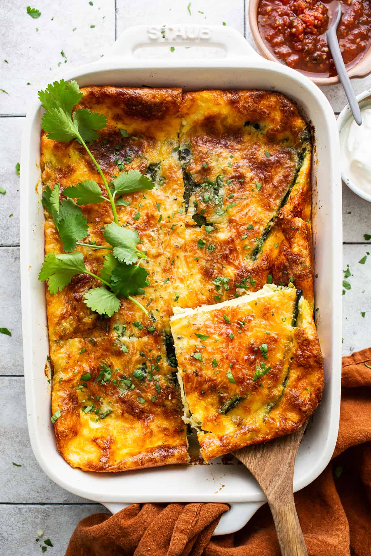 A slice of chile relleno casserole on a serving spoon.