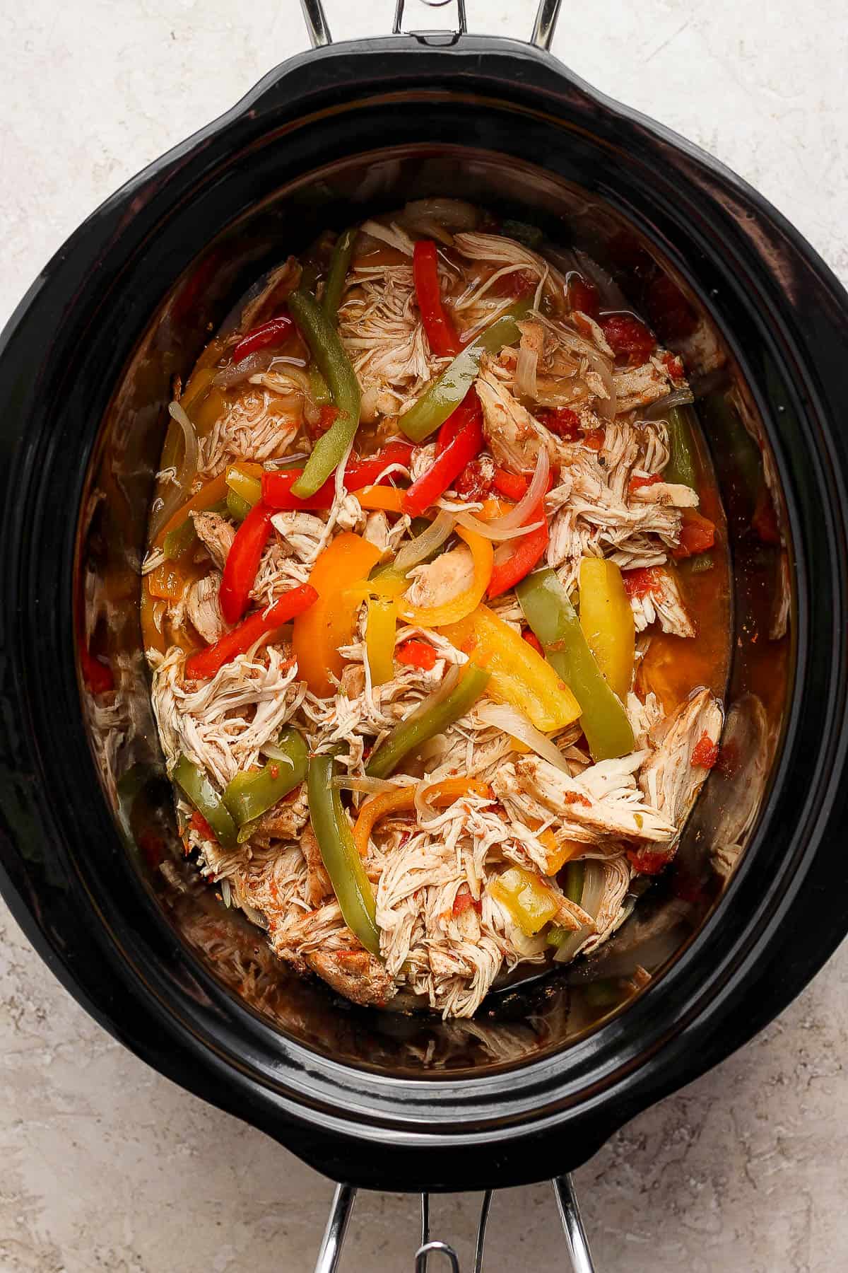 Crockpot chicken fajitas in a slow cooker ready to be served.