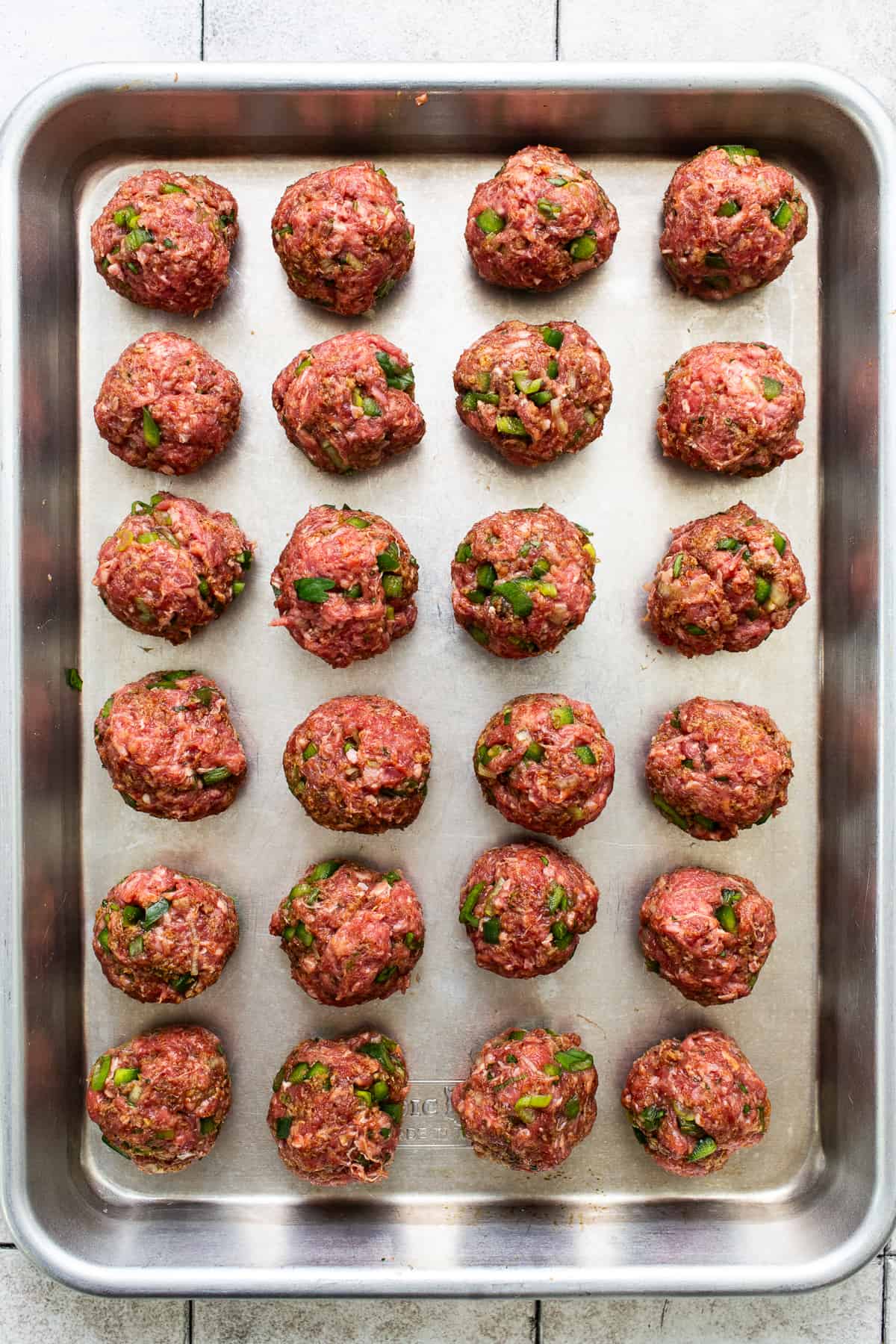 Beef meatballs on a baking sheet.