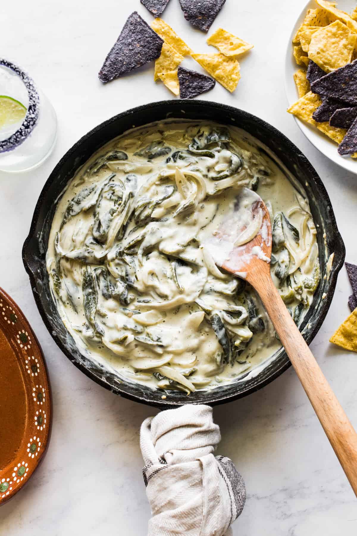 Rajas con crema in a skillet with tortilla chips.