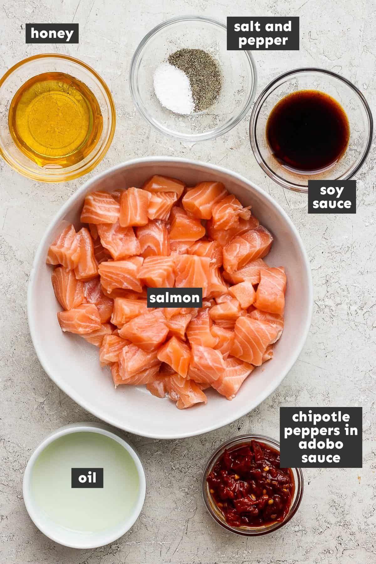 Ingredients in chipotle honey air fryer salmon bites on a table.