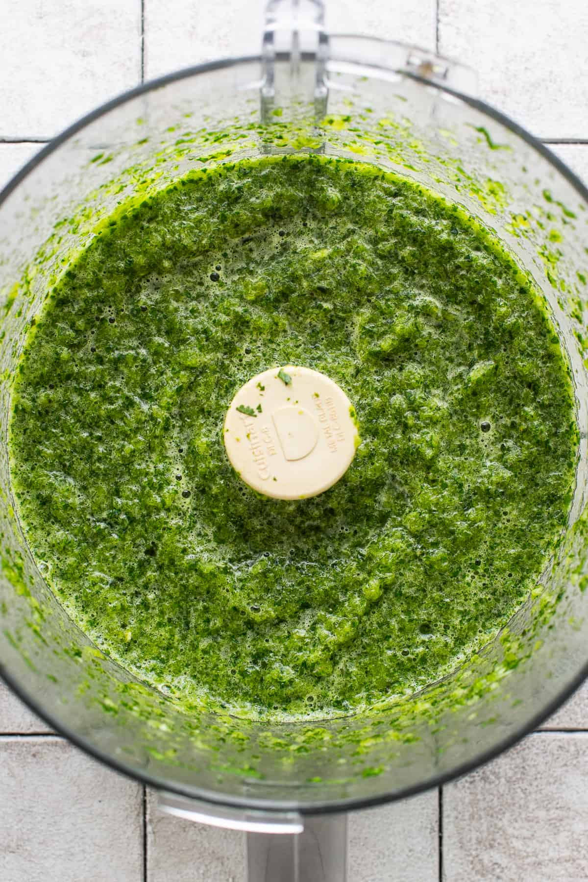 Blended roasted poblanos, jalapeño, onions, and herbs in a food processor.