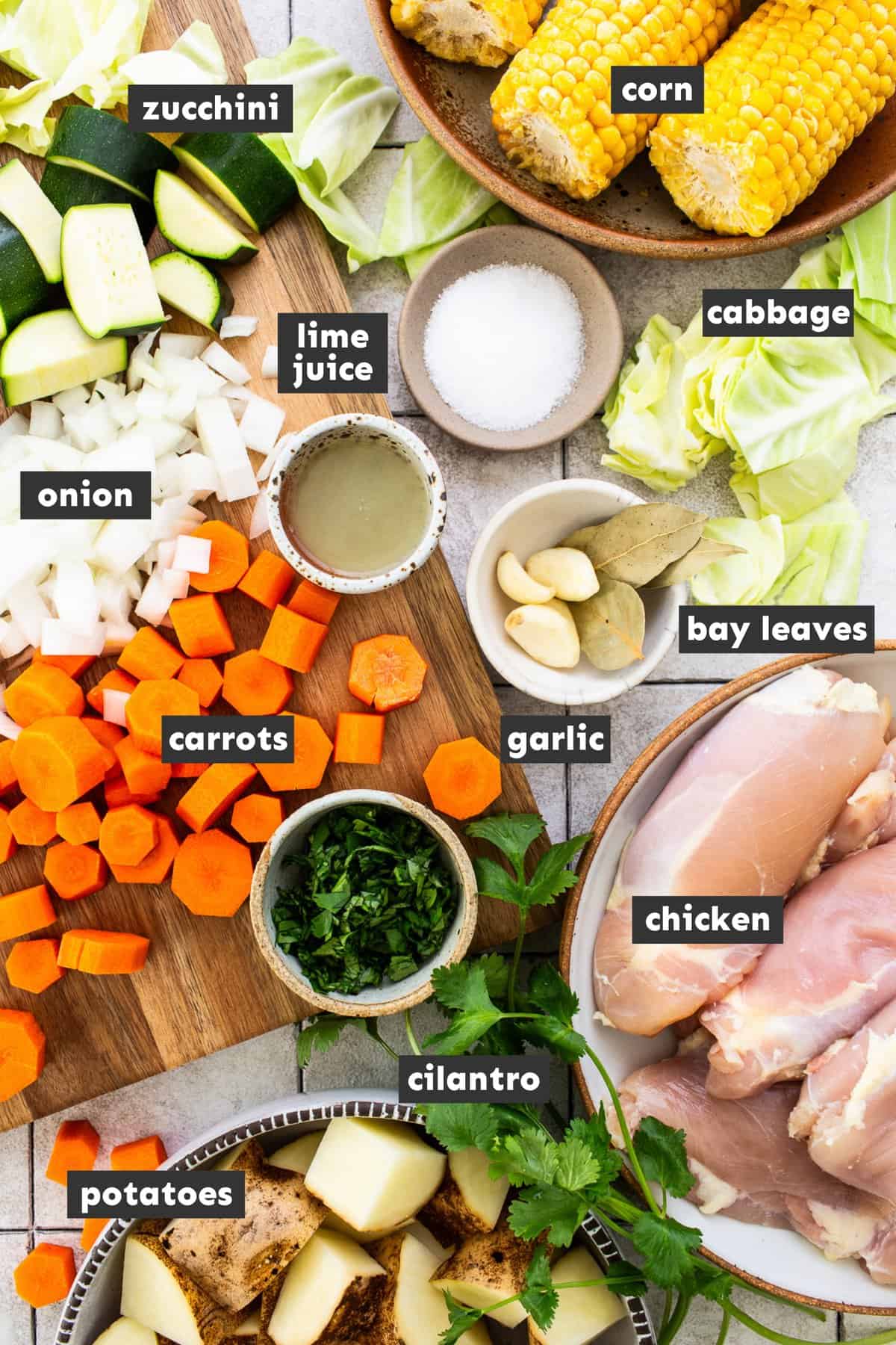 Ingredients for caldo de pollo on a table.