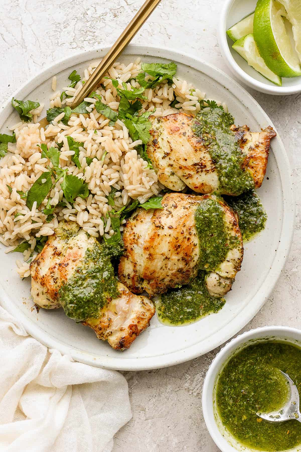 Chimichurri Chicken served with more chimichurri sauce and a side of rice.