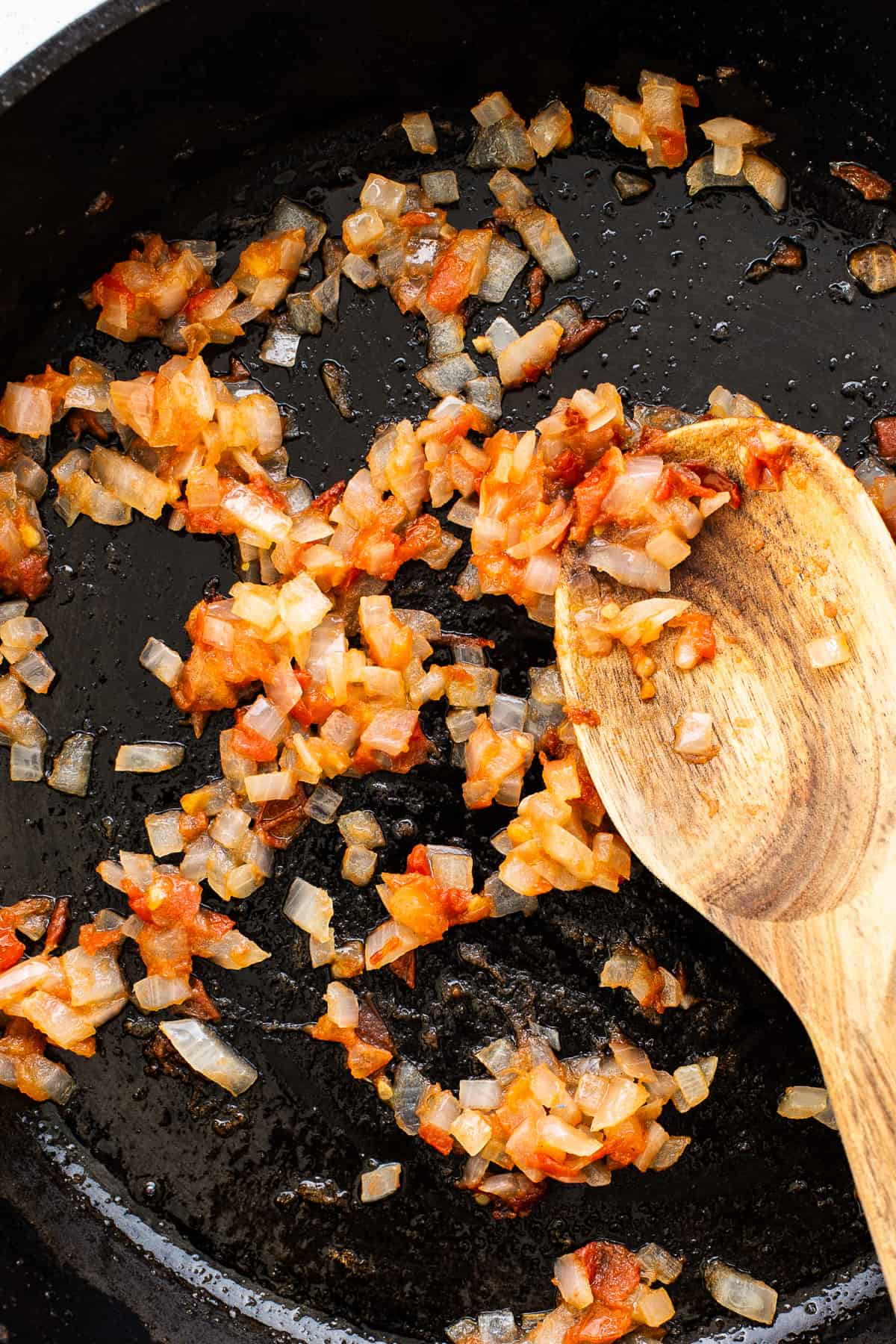 Sauteed onions, tomatoes, and garlic in a skillet.
