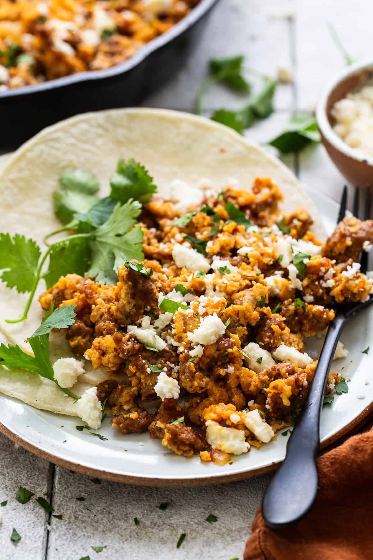 Chorizo and eggs on a plate with corn tortillas