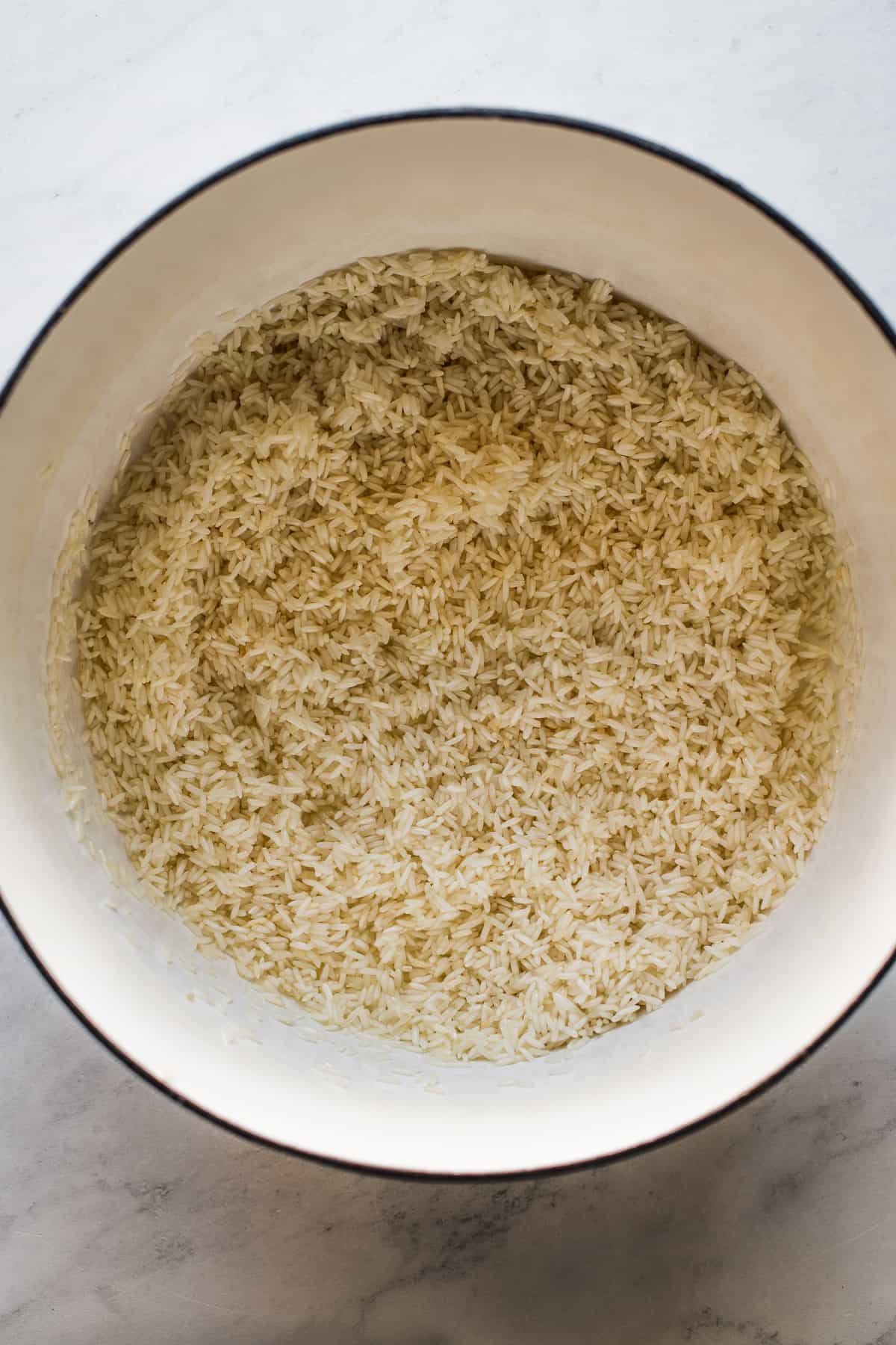 Long grain white rice toasting in a Dutch oven.