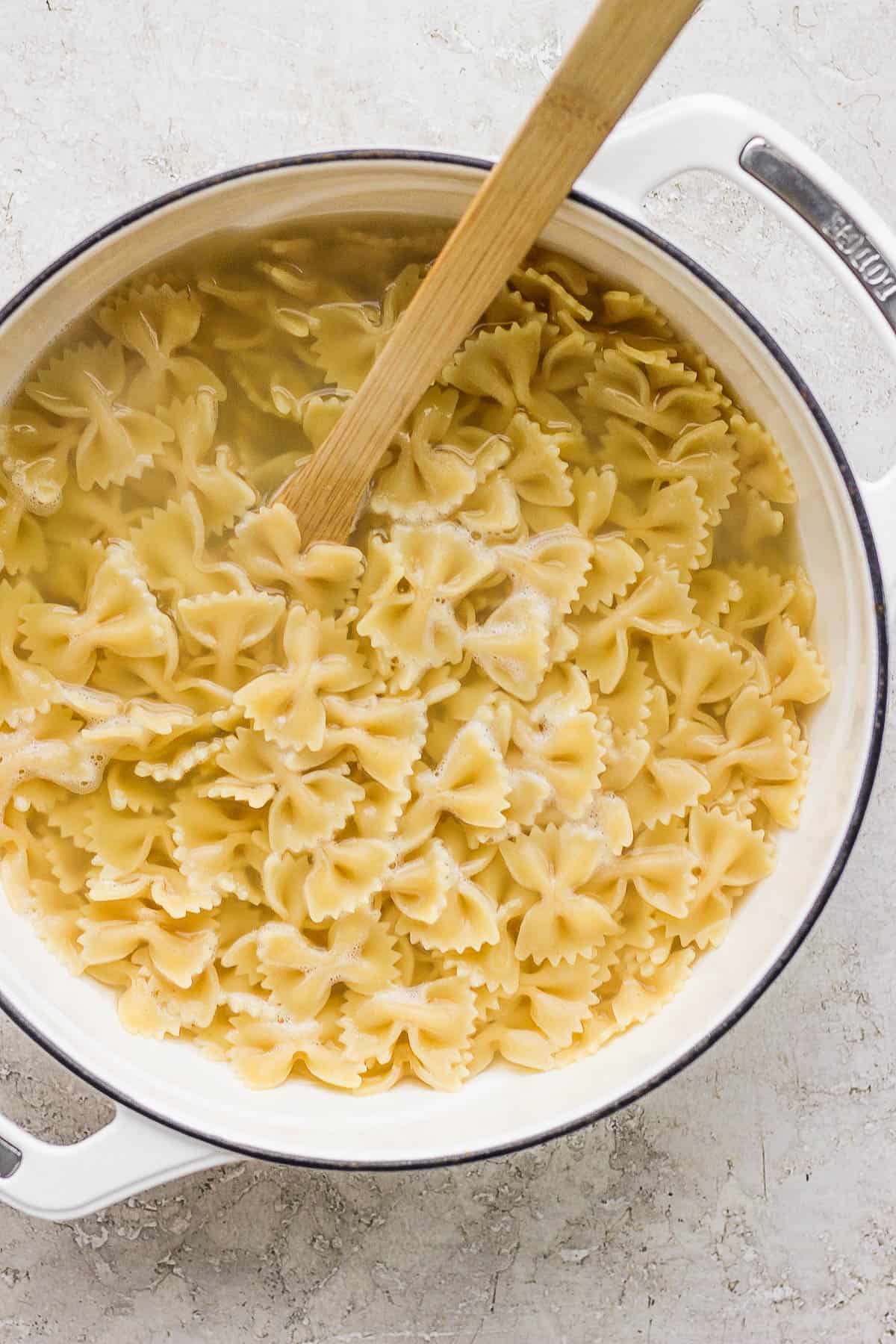 Cooked bow-tie pasta in a pot.