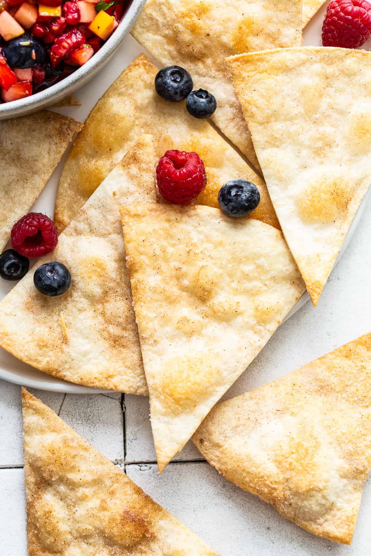 Baked crispy cinnamon chips made from flour tortillas on a plate.