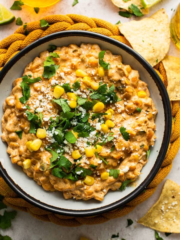 Street corn dip in a bowl with tortilla chips.
